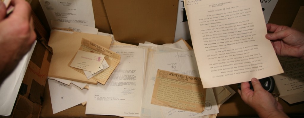 Examining documents from the time capsule opened for Covington's bicentennial.  Photo by David Barfield