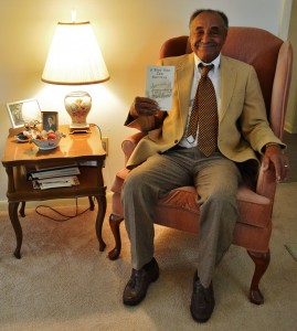 Mr. Murray James, Jr. with his book, "A Poor Man Can Survive"