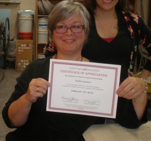 Robin Games with the Outstanding Volunteer of the Quarter certificate.