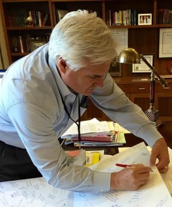District Attorney Warren Montgomery signs a card for the "Socks for Seniors" program.